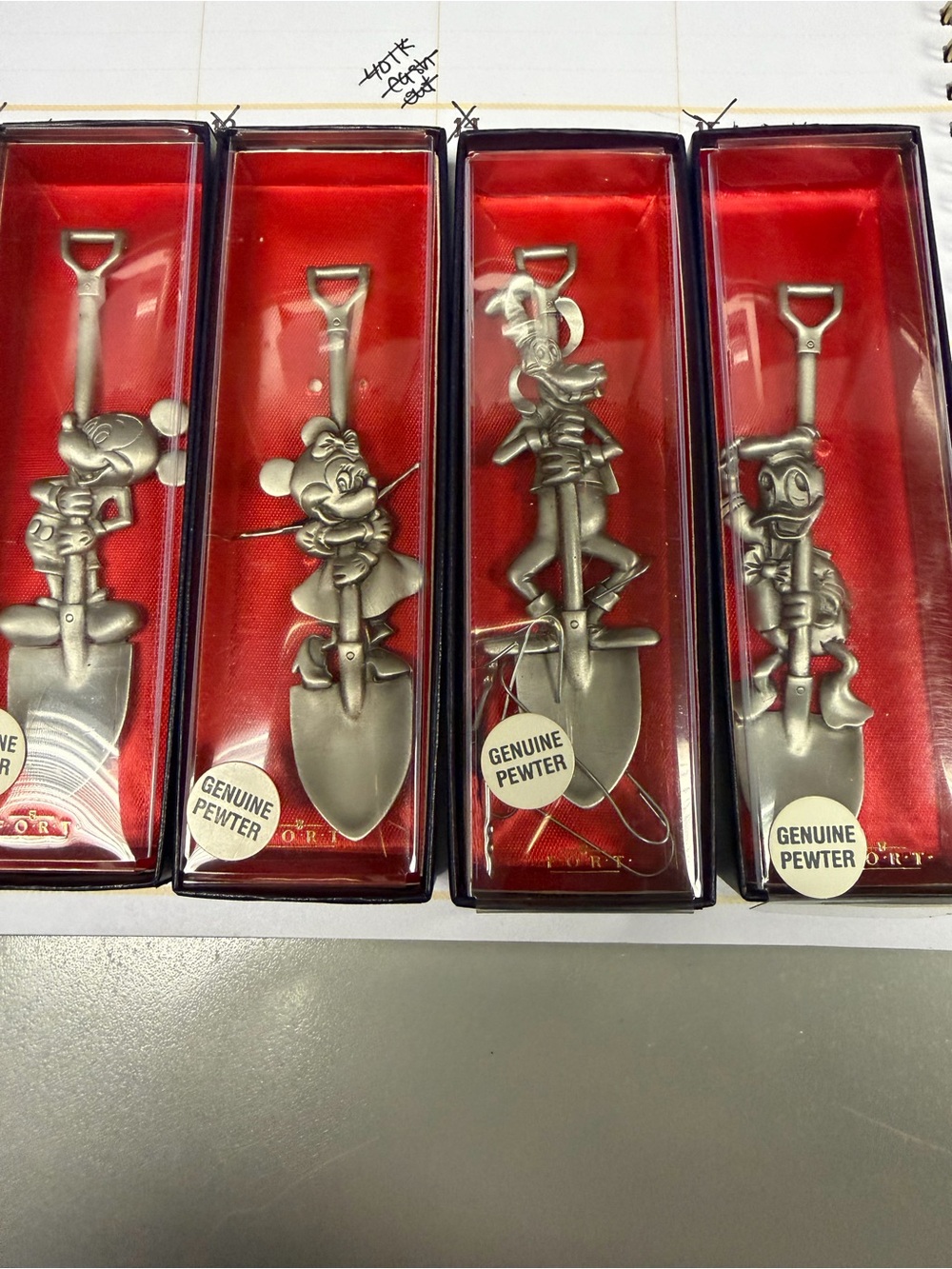 Disney Pewter Character Garden Shovels in Silver and Red Display